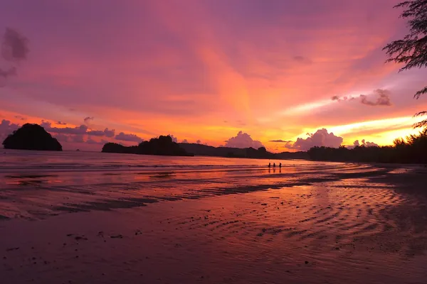 Orange sunset over the sea and limestone islands at Ao Nang, Thailand