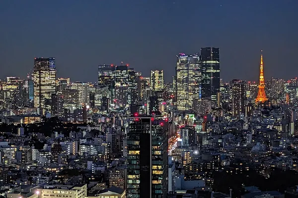 Tokyo skyline at night with Tokyo Tower lit up, seen from Shibuya
