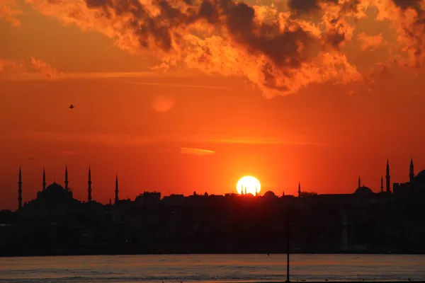Sunset behind the Blue Mosque skyline, seen from the Bosphorus, Istanbul