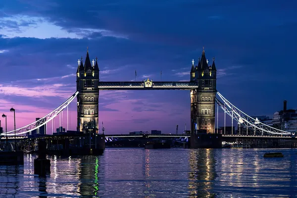 Tower Bridge over the River Thames lit up at dusk, London